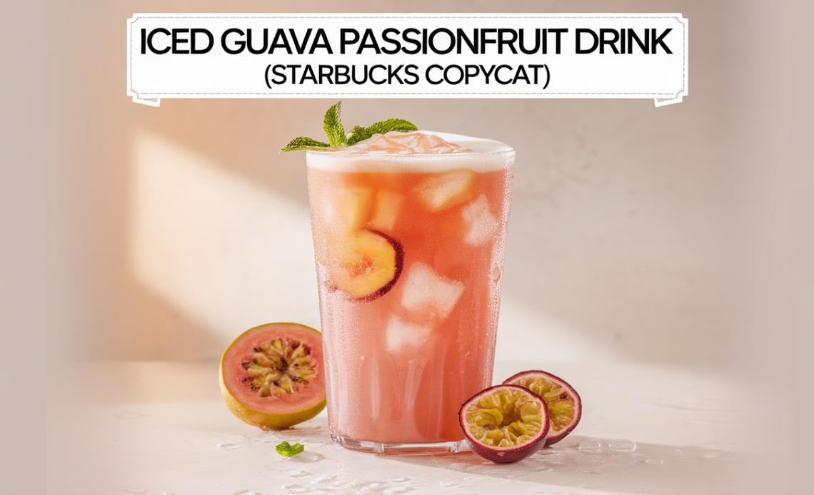 A tall glass of iced guava passionfruit drink with a creamy pink hue, garnished with ice cubes and a slice of pineapple.