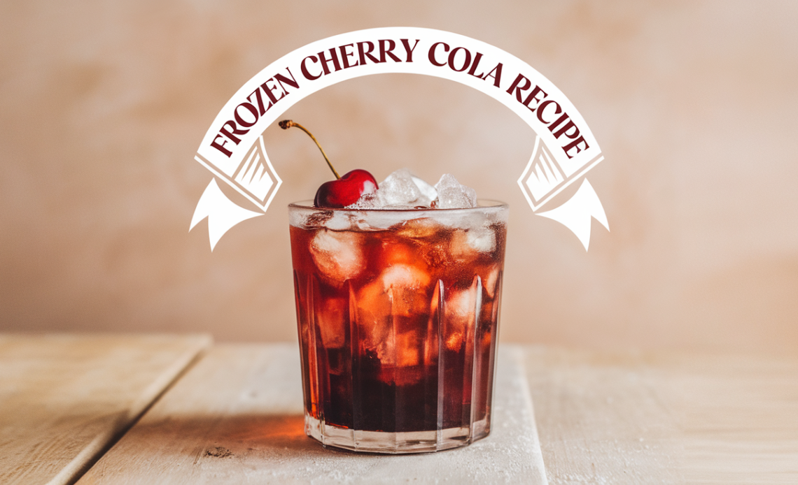 A frosty glass of frozen cherry cola with a swirl of whipped cream and maraschino cherry on top, served with a straw.